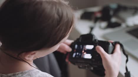 Female-photographer-reviewing-photos-on-her-camera