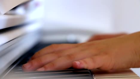 Playing-piano-in-close-up,-side-view,-stabilized