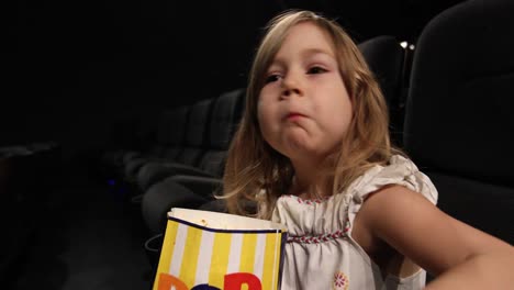little-child-eating-popcorn-in-the-cinema
