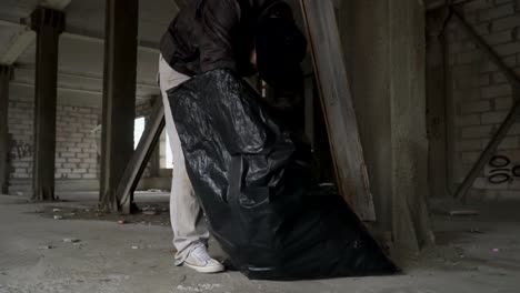 Dirty-bum-searches-something-in-garbage-bag