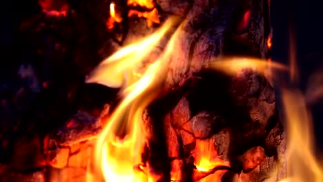 Campfire-In-The-Night.-Time-Lapse.-Burning-logs-in-orange-flames-closeup.-Background-of-the-fire.-Beautiful-fire-burns-brightly.-Embers-of-the-fire-climb-up.-Red-flames-surging-up