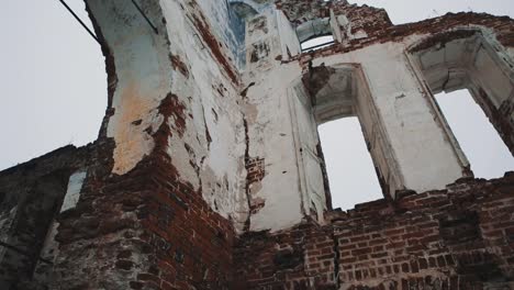 Inside-destroyed-orthodxal-temple,-red-bricks-walls,-cold-cloudy-day