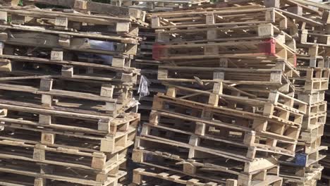 Wooden-pallets-stacked-in-the-warehouse.-Cargo-delivery-on-pallets