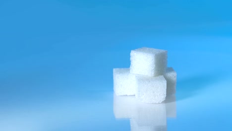 Table-top-shot-Group-of-Sugar-cubes-vary-position-on-light-blue-background