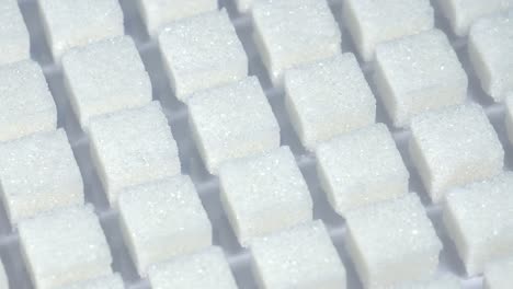 Table-top-shot-Group-of-Sugar-cubes-vary-position-on-light-blue-background