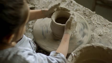 Little-Girl-Making-Pottery-on-Spinning-Wheel