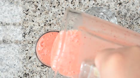 Strawberry-and-banana-and-orange-cocktail.	Cocktail-is-poured-in-glasses.