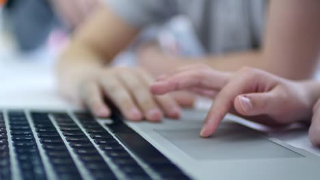 Hands-of-Child-Using-Computer-Touchpad