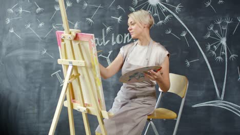 Female-Artist-Creating-Painting-in-Art-Studio