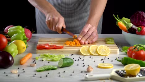 Chef-is-cutting-vegetables-in-the-kitchen,-slicing-carrot