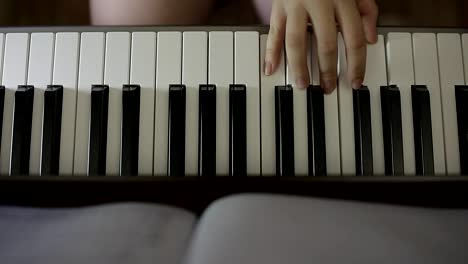 Hands-teenager-girl-playing-on-the-keyboard-of-the-digital-piano