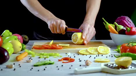 Man-is-cutting-lemon-in-the-kitchen