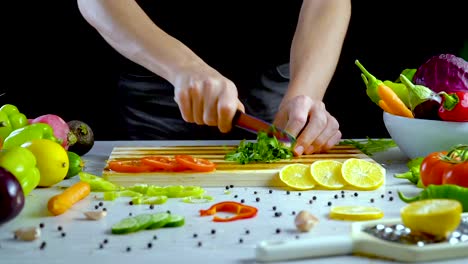 Man-is-chopping-parsley-in-the-kitchen