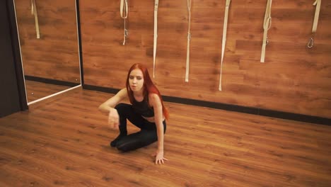 Cute-girl-with-red-hair-does-yoga-exercises