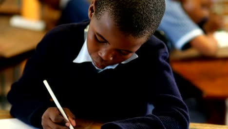 Schoolboy-studying-in-the-classroom-at-school-4k