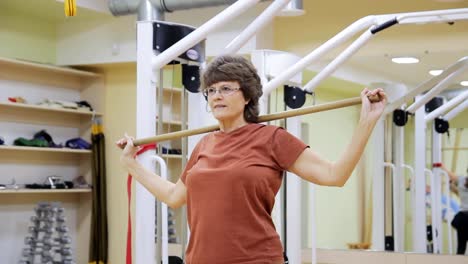 Senior-woman-doing-exercises-in-fitness-room.