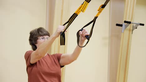 Senior-woman-doing-exercises-in-fitness-room.