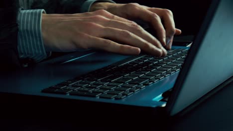 Man's-hands-typing-text-on-a-laptop