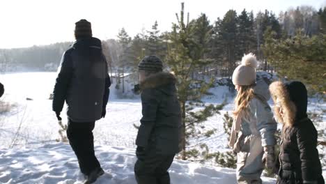 Family-Standing-Over-Snowy-Frozen-Lake