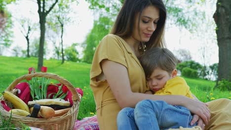 Mother-with-her-son-napping-in-her-arms