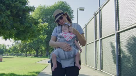 Mother-caressing-her-sleeping-baby-at-a-park