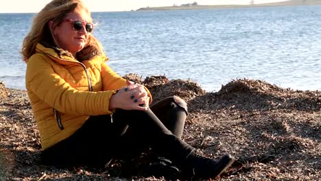 Sad-pensive-woman-on-winter-sea-beach