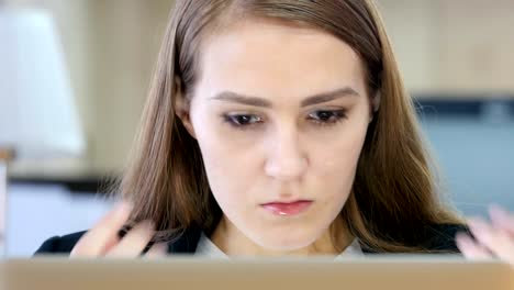 Angry-Woman-Working-on-Laptop-in-Office