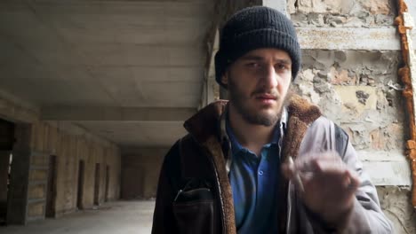 Homeless-looks-in-camera-and-smokes-cigarette