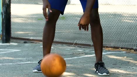 African-American-man-skillfully-handling-ball-before-throwing,-slow-motion