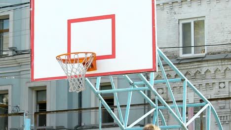 Player-dribbling-ball-from-center-of-field,-putting-it-in-basket-and-missing