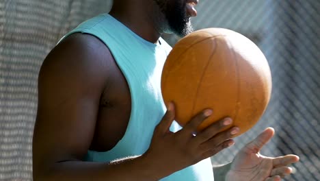 Active-african-man-bouncing-the-ball,-exercises-outside,-hobby-and-recreation