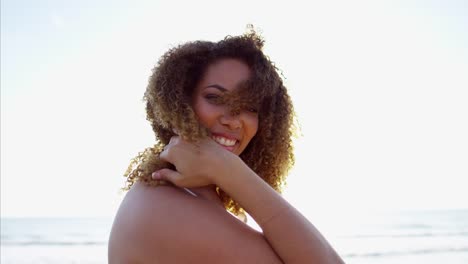 Portrait-of-African-American-female-relaxing-on-beach