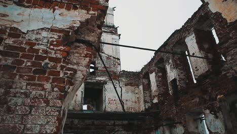 Inside-destroyed-orthodxal-church-red-bricks-walls,-cold-cloudy-day