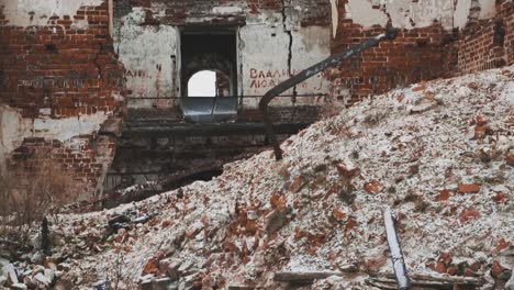 Old-destroyed-orthodoxal-church-building,-piles-of-bricks-covered-in-snow