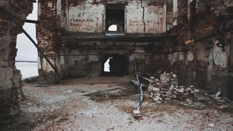 Inside-ruined-orthodxal-temple-red-bricks-walls,-cold-cloudy-day