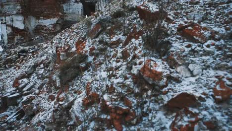 Old-abandoned-orthodoxal-cathedral-building,-piles-of-bricks-covered-in-snow