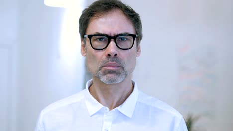 Sad-Casually-Sitting-Middle-Aged-Man-in-Office,-Library