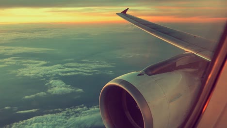 Airplane-view-window-concept.-View-on-window-airplane-see-engine-and-wing-on-cloud-and-sky-blue-or-azure-sky-on-land-beautiful.