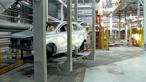 huge-robotic-trolley-is-transporting-not-painted-car-body-in-workshop