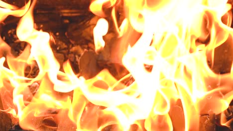 Burning-flames-of-fire-in-slow-motion-against-the-background-of-coals