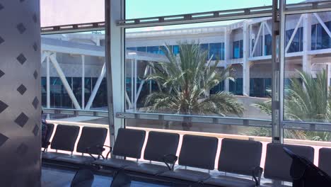 Empty-modern-airport-interior-with-seats-and-big-window