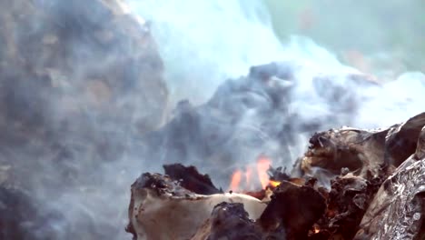 Fire-slow-motion-burning-on-garbage-pile-to-air-pollution