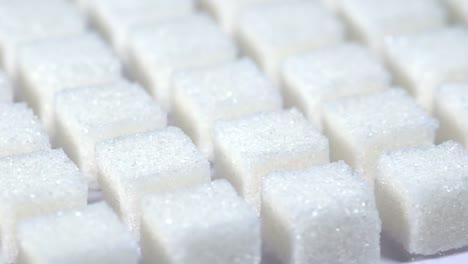 Table-top-shot-Group-of-Sugar-cubes-vary-position-on-light-blue-background