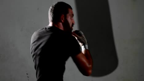 Male-bearded-boxer-exercising-shadow-boxing.