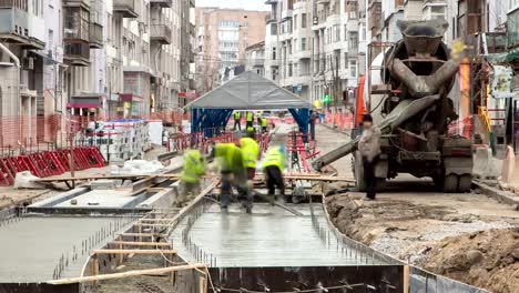 Concrete-works-for-road-maintenance-construction-with-many-workers-and-mixer-timelapse