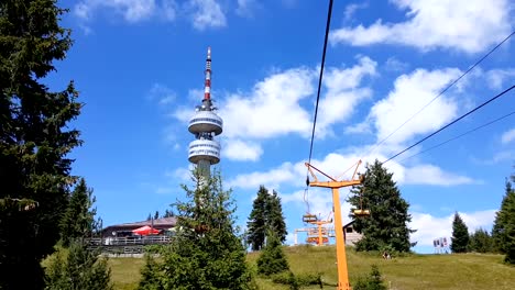 Empty-chair-lift-ascending-in-Pamporovo-winter-mountain-ski-resort-in-Bulgaria-during-summer.