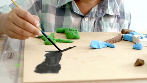 Child's-hands-playing-colorful-clay-and-paint-on-table.-Development-of-fine-motor-skills-of-fingers-and-creativity,-education