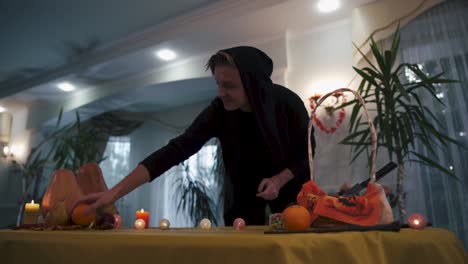 Halloween.-Magician-in-the-black-overalls-comes-to-the-festive-table.