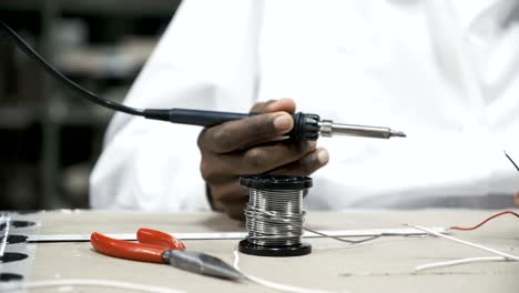 Hands-soldering-wires-at-work