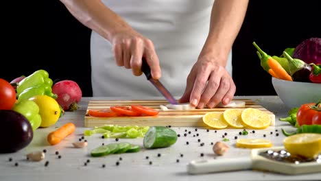 Chef-is-cutting-black-turnip-in-the-kitchen,-slicing-black-radish